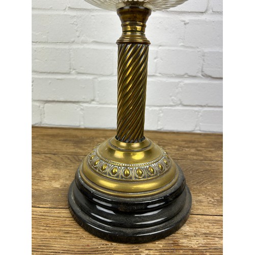 524 - A BRASS OIL LAMP WITH GLASS SHADE,