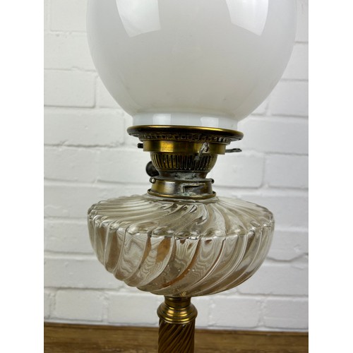 524 - A BRASS OIL LAMP WITH GLASS SHADE,