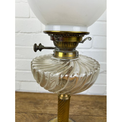 524 - A BRASS OIL LAMP WITH GLASS SHADE,