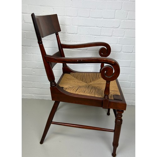 441 - AN EARLY 20TH CENTURY ARMCHAIR OR DESK CHAIR, 

Flame mahogany with scroll arms and cane upholstered... 