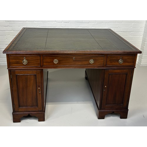 440 - AN EARLY 19TH CENTRAL PARTNERS DESK, 

Two pedestals, each with ten drawers with brass handles. Gree... 