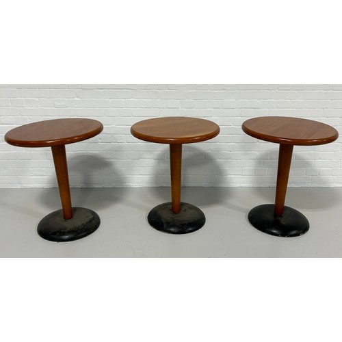 536 - A SET OF THREE BAR TABLES, 

Wooden tops on weighted metal bases.