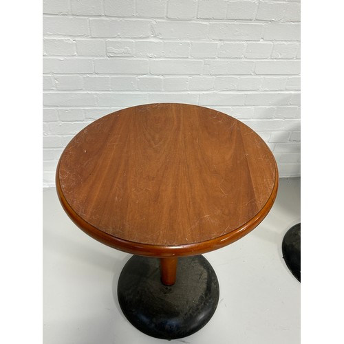 536 - A SET OF THREE BAR TABLES, 

Wooden tops on weighted metal bases.