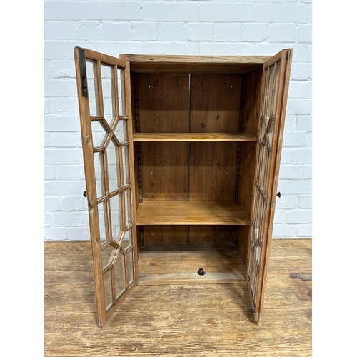 419 - A PINE CABINET WITH 'CRISS CROSS' GLAZED DOORS,

76cm x 46cm x 29cm