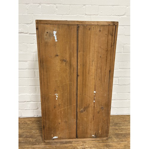 419 - A PINE CABINET WITH 'CRISS CROSS' GLAZED DOORS,

76cm x 46cm x 29cm