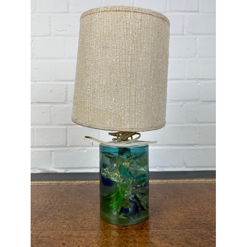 546 - AN UNUSUAL GLASS OR RESIN TABLE LAMP, 

14cm H

With hessian shade.