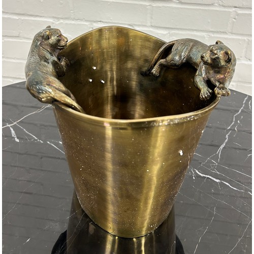 565 - EICHOLTZ: A BRASS CHAMPAGNE COOLER WITH LION HANDLES,