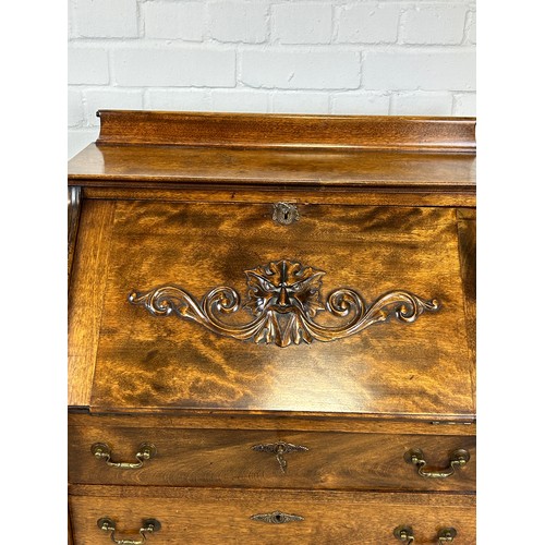 530 - AN OAK 'GREEN MAN' BUREAU, 

Drop front over three drawers. 

111cm H x 68cm W x 44cm D