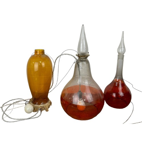 559 - A PAIR OF GLASS 'ALCHEMIST JAR' LIGHTS ALONG WITH AN AMBER GLASS LAMP (3), 

Largest 57cm H