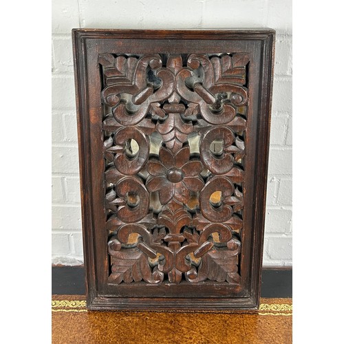 567 - A CARVED FLORAL SCROLL OAK PANEL WITH MIRRORED BACK, 

56cm x 35cm x 5cm