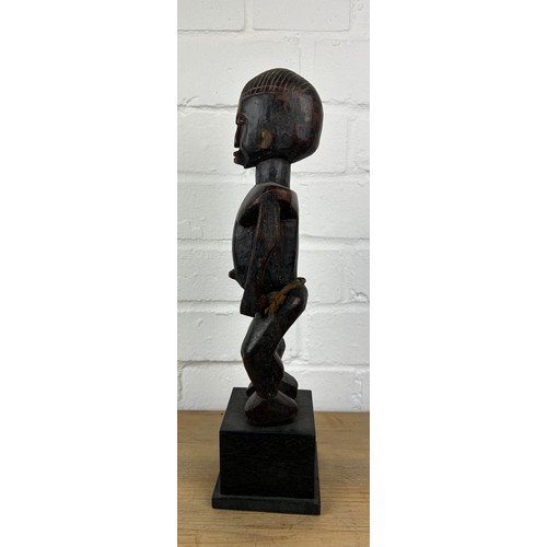 242 - AN AFRICAN TRIBAL WOODEN MALE FIGURE, 

Mounted on wooden stand. 

28cm H
On stand 36cm H