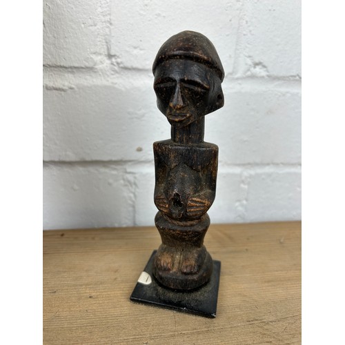 239 - THREE AFRICAN TRIBAL WOODEN ITEMS (3) 

To include a figure, phallic shaped plaque and another. 

Fi... 