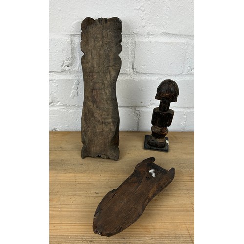 239 - THREE AFRICAN TRIBAL WOODEN ITEMS (3) 

To include a figure, phallic shaped plaque and another. 

Fi... 