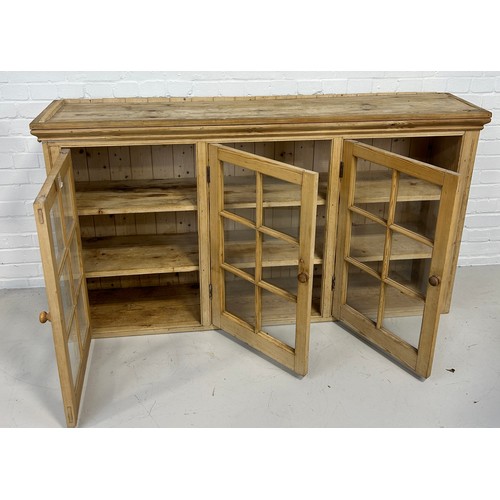 572 - A LARGE PINE BOOKCASE WITH THREE GLAZED DOORS REVEALING A SHELVED INTERIOR, 

162cm x 92cm x 35cm