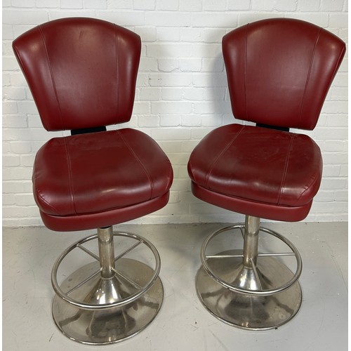 494 - A PAIR OF POKER SWIVEL STOOLS UPHOLSTERED IN RED LEATHER WITH PICASSO STYLE FACES IN YELLOW TO BACKS... 