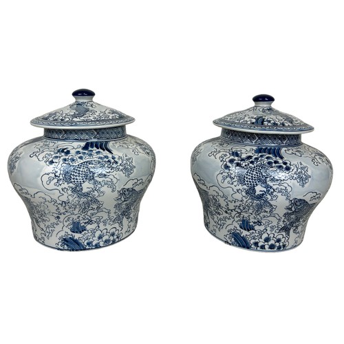 216 - A PAIR OF LARGE CHINESE 'CARP' DESIGN LIDDED JARS, 

34cm x 34cm each.