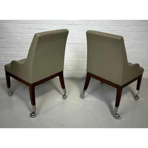 492 - A PAIR OF POKER CHAIRS UPHOLSTERED IN LEATHER FABRIC RAISED ON CHROME CASTORS (2), 

95cm x 58cm x 5... 