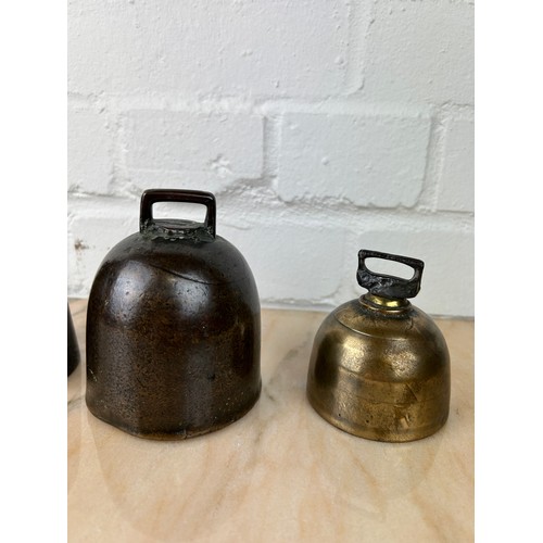 234 - THREE CAST IRON AND BRONZE BELLS (3), 

Largest 12cm x 7cm