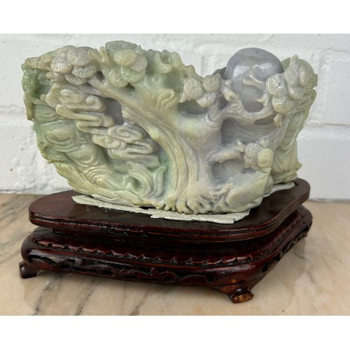 204 - A CHINESE JADE GROUP ON ROSEWOOD STAND,

Probably 20th Century or modern. 

Jade 20cm x 11cm