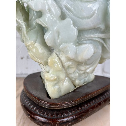 205 - A CHINESE JADE FIGURE OF A LUOHAN ON ROSEWOOD STAND, 

Probably 20th century or modern. 

Jade 24cm ... 