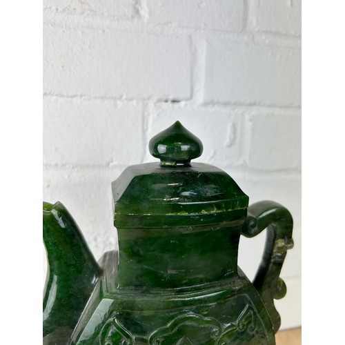 208 - A LARGE CHINESE JADE OR JADEITE TEA POT AND COVER ON ROSEWOOD STAND, 

The jade teapot 25cm H