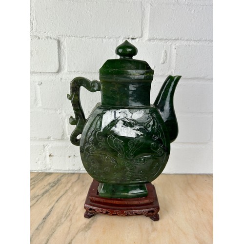 208 - A LARGE CHINESE JADE OR JADEITE TEA POT AND COVER ON ROSEWOOD STAND, 

The jade teapot 25cm H