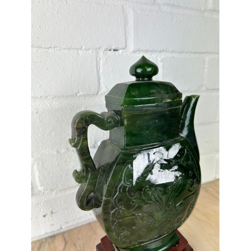 208 - A LARGE CHINESE JADE OR JADEITE TEA POT AND COVER ON ROSEWOOD STAND, 

The jade teapot 25cm H