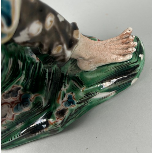 175 - A JAPANESE PORCELAIN GROUP DEPICTING A MAN HOLDING A FROG, 

26cm x 15cm