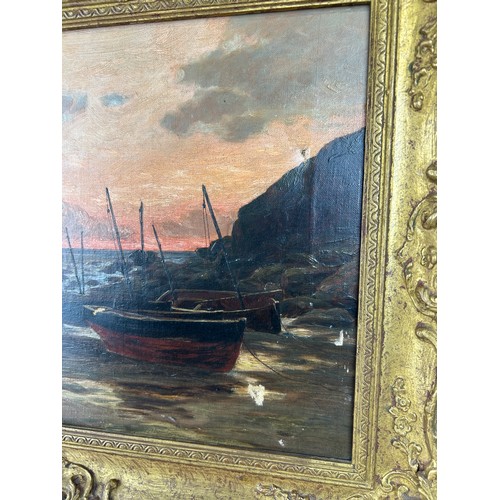 64 - AN OIL ON CANVAS PAINTING DEPICTING BOATS BESIDES THE SEA, 

44cm x 29cm 

Mounted in a gilt frame.