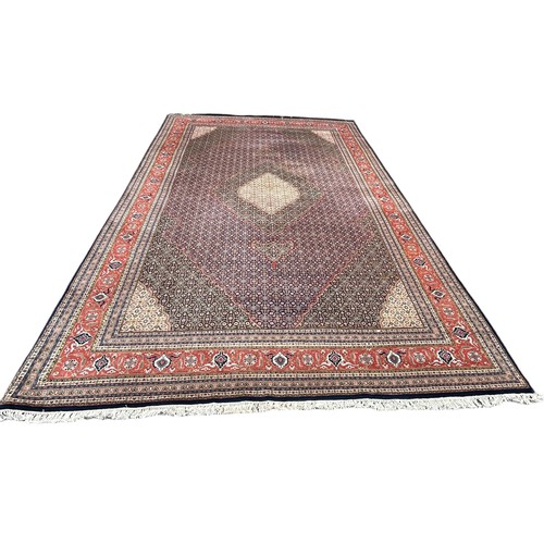 636 - A VERY LARGE AND FINE PERSIAN CARPET WITH LABEL FROM HARRODS FOR £9,950,

630cm x 315cm