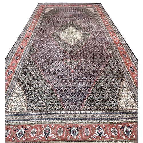 636 - A VERY LARGE AND FINE PERSIAN CARPET WITH LABEL FROM HARRODS FOR £9,950,

630cm x 315cm