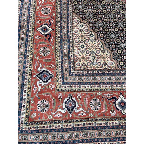 636 - A VERY LARGE AND FINE PERSIAN CARPET WITH LABEL FROM HARRODS FOR £9,950,

630cm x 315cm