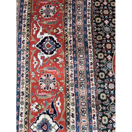 636 - A VERY LARGE AND FINE PERSIAN CARPET WITH LABEL FROM HARRODS FOR £9,950,

630cm x 315cm