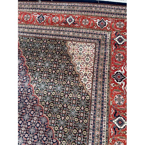 636 - A VERY LARGE AND FINE PERSIAN CARPET WITH LABEL FROM HARRODS FOR £9,950,

630cm x 315cm