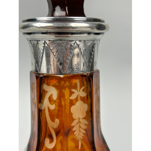 259A - AN AMBER GLASS DECANTER WITH SILVER COLLAR CIRCA 1900, 

30cm H

Possibly Venetian, or Spanish.