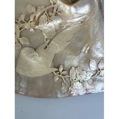 73 - A CHINESE MOTHER OF PEARL CARVING WITH A BIRD, 

20cm x 18cm