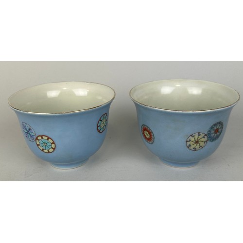 83 - A PAIR OF CHINESE LILAC GROUND CUPS DECORATED WITH FLOWERS, 

Kangxi six character marks to verso, b... 