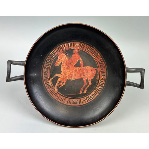 8 - AN APULIAN POTTERY KYLIX DECORATED WITH A HORSE AND RIDER CIRCA 5TH CENTURY B.C. 

33cm x 25.5cm x 9...