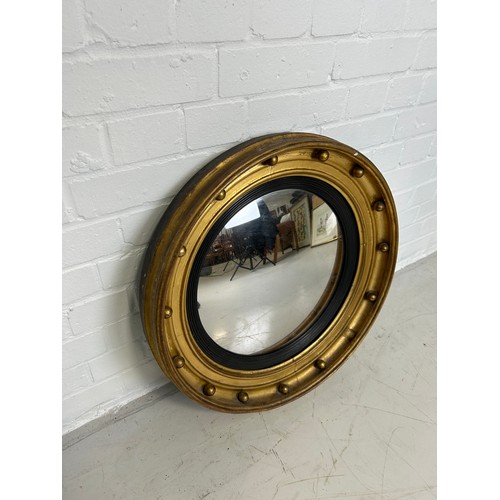 440 - A 19TH CENTURY REGENCY DESIGN CIRCULAR WALL MIRROR, 

56cm W x 10cm D