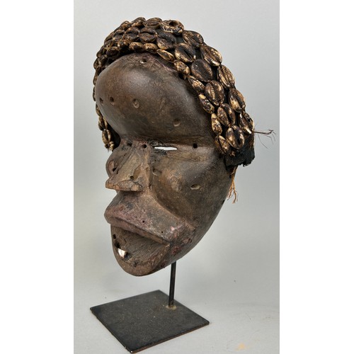 608 - AN AFRICAN TRIBAL MASK WITH SHELL DETAIL, 

26cm x 20cm 

Mounted on stand 32cm H