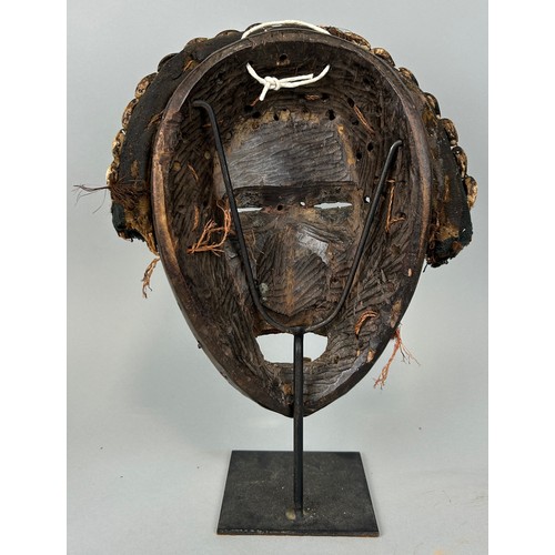 608 - AN AFRICAN TRIBAL MASK WITH SHELL DETAIL, 

26cm x 20cm 

Mounted on stand 32cm H