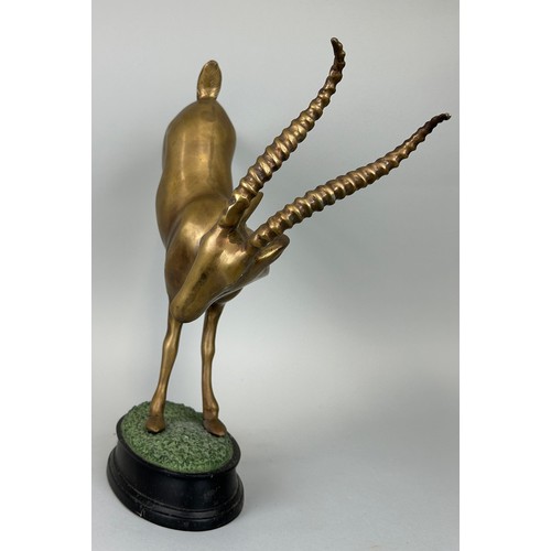 517 - A HOLLYWOOD REGENCY DESIGN BRONZE KUDU ON NATURALISTIC STAND, 

52cm x 44cm x 12cm