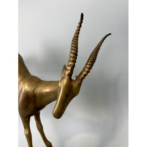 517 - A HOLLYWOOD REGENCY DESIGN BRONZE KUDU ON NATURALISTIC STAND, 

52cm x 44cm x 12cm