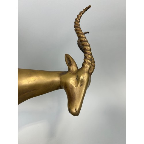 517 - A HOLLYWOOD REGENCY DESIGN BRONZE KUDU ON NATURALISTIC STAND, 

52cm x 44cm x 12cm