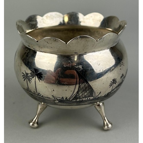 163 - AN ARABIC SILVER BOWL ON TRIPOD STAND, 

Nielo decorated with palm trees. 

Signed to the side. 

We... 