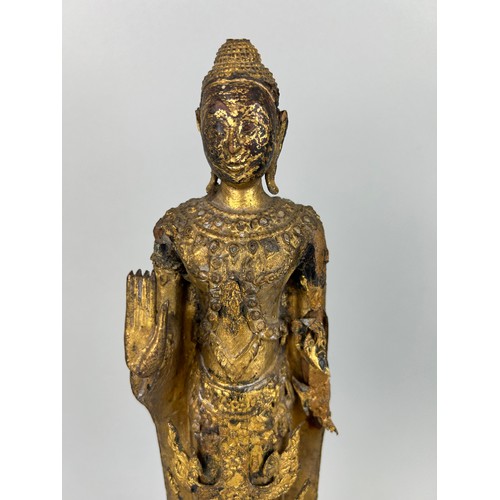 122 - A CARVED GILT WOOD CARVED FIGURE OF A BUDDHA, 

Possibly 19th Century.