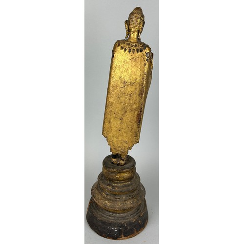 122 - A CARVED GILT WOOD CARVED FIGURE OF A BUDDHA, 

Possibly 19th Century.