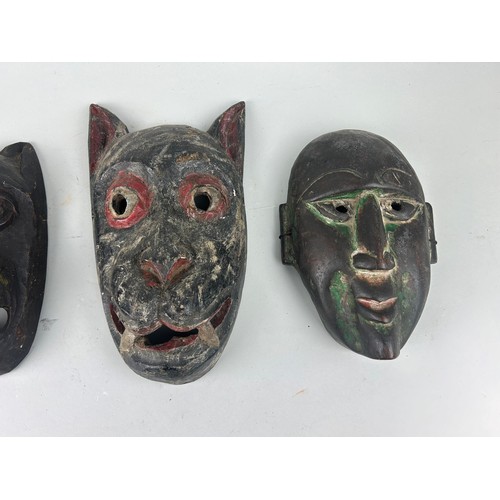 119 - A GROUP OF FOUR AFRICAN TRIBAL MASKS (4), 

Largest 27cm x 14cm