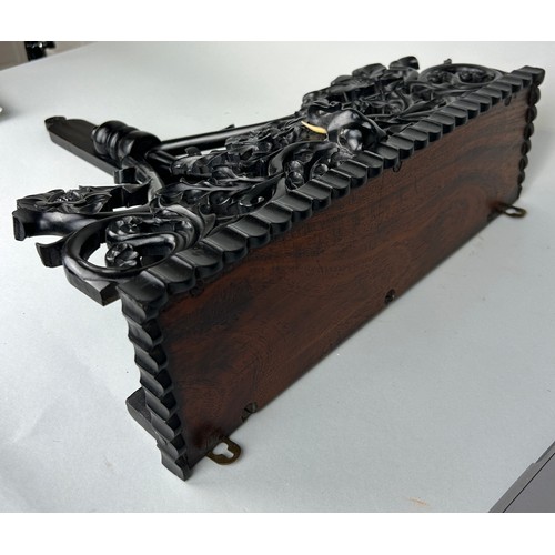 487 - AN EBONISED WOODEN WALL SHELF WITH ELEPHANT, 

52cm x 40cm

Ivory exemption license: VF1XCS3L