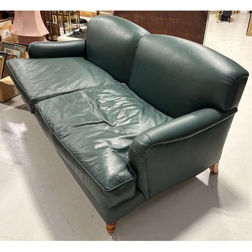 445 - A LARGE TWO SEATER HOWARD STYLE SOFA UPHOLSTERED IN GREEN LEATHER FABRIC, 

Raised on four legs, the... 